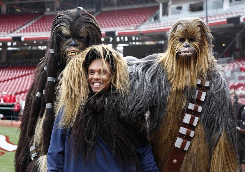 Milwaukee Brewers center fielder Carlos Gomez, middle, poses with Star Wars characters Tarfful, left, and Chewbacca, right, as part of Star Wars night prior to a game with the Cincinnati Reds at Great American Ball Park. David Kohl-USA TODAY Sports