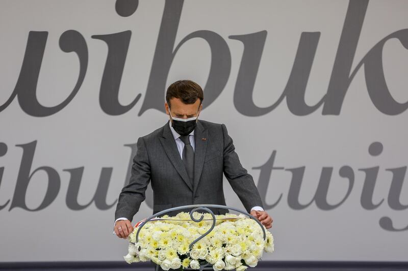 French President Emmanuel Macron lays a wreath at the genocide memorial site in the capital Kigali, Rwanda Thursday, May 27, 2021. In a key speech on his visit to Rwanda, Macron said he recognizes that France bears a heavy responsibility for the 1994 genocide in the central African country. (AP Photo/Muhizi Olivier)