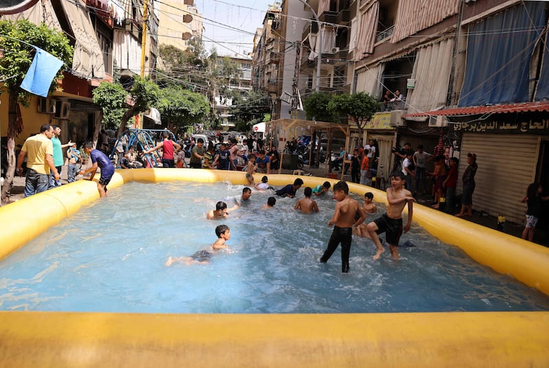 Beirut children play in an inflatable swimming pool set up by supporters of former Lebanese prime minister Saad Hariri, who have boycotted the country's elections. AFP
