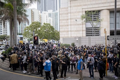People gather outside the West Kowloon Magistrates’ Courts during a hearing for 47 opposition activists charged with violating the city’s national security law in Hong Kong, China, on Monday, March 1, 2021. Defiant Hong Kong protesters risked arrest outside a local court in the biggest demonstration in months, as dozens of the city’s most prominent pro-democracy activists were jailed on subversion charges and authorities in Beijing moved to limit the opposition’s role in future elections. Photographer: Paul Yeung/Bloomberg