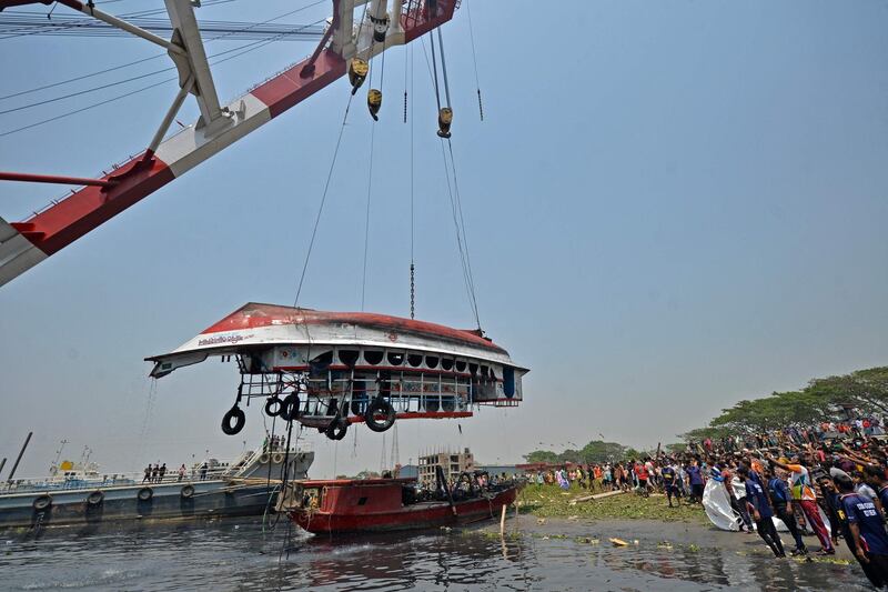 Onlookers gather as the authorities recover a capsized boat in the Shitalakshya, Narayanganj, Bangladesh. AFP