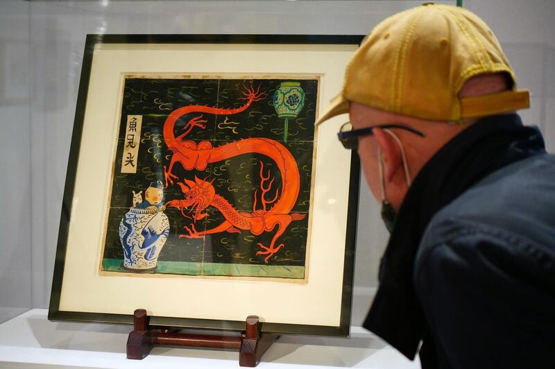 Painting for the original cover of "The Blue Lotus" (Lotus Bleu) Tintin comic book (1936), is displayed before being auctioned by Artcurial in Paris, France January 13, 2021. REUTERS/Noemie Olive  NO RESALES. NO ARCHIVES