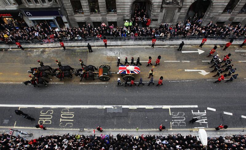 LONDON, ENGLAND - APRIL 17:  The coffin carried on a horse drawn gun carriage during the Ceremonial funeral of former British Prime Minister Baroness Thatcher on Fleet Street on April 17, 2013 in London, England. Dignitaries from around the world today join Queen Elizabeth II and Prince Philip, Duke of Edinburgh as the United Kingdom pays tribute to former Prime Minister Baroness Thatcher during a Ceremonial funeral with military honours at St Paul's Cathedral. Lady Thatcher, who died last week, was the first British female Prime Minister and served from 1979 to 1990.  (Photo by Peter Macdiarmid/Getty Images) *** Local Caption ***  166796152.jpg