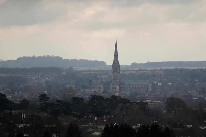 FILE - In this Tuesday, March 13, 2018 file photo the combined tower and spire of Salisbury Cathedral stand surrounded by the medieval city where former Russian double agent Sergei Skripal and his daughter were found critically ill following exposure to the Russian-developed nerve agent Novichok in Salisbury, England. (AP Photo/Matt Dunham, File)