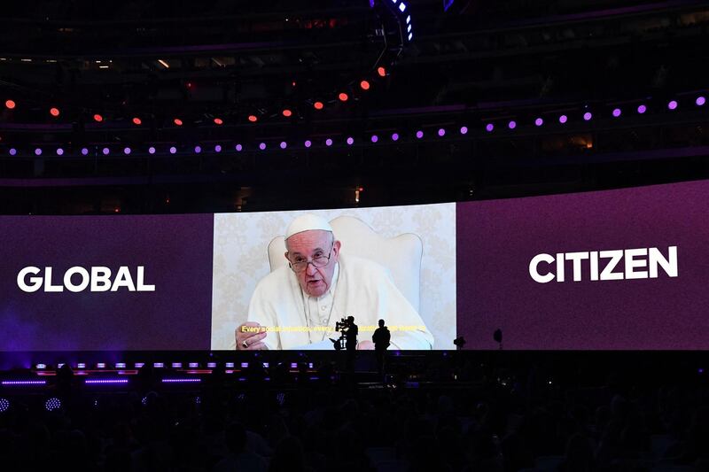 Pope Francis is seen on a screen during the taping of the Vax Live concert. AFP