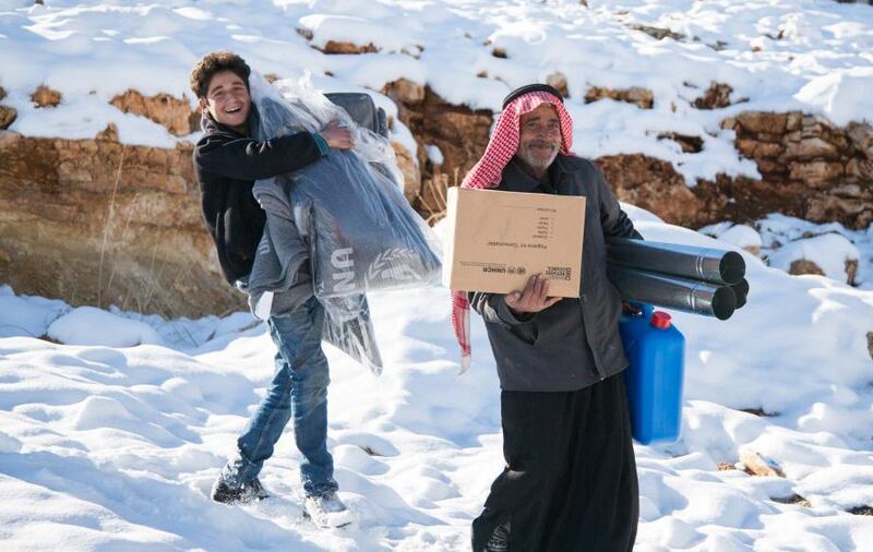 Refugees are given a stove in Arsal last month, as part of the UNHCR efforts to help them battle the bitter winter conditions. Courtesy UNHCR