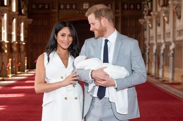 Britain's Prince Harry, Duke of Sussex, and his wife Meghan, Duchess of Sussex, pose for a photo with their newborn baby son Archie. AFP