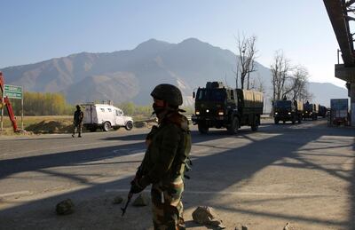 epa07489811 Indian army and paramilitary soldiers stand guard as an Indian Army convoy crosses the national highway on the outskirts of Srinagar, the summer capital of Indian Kashmir, 07 April 2019. The Jammu and Kashmir government has banned civilian traffic on Srinagar-Jammu national highway for two days in a week (Sunday and Wednesday) for safe passage of Indian security forces convoys. The authorities have deployed civil magistrates on the highway to facilitate travel of medical emergencies, students and tourists on highway by giving them on-spot travel passes. Earlier, after February 14 suicide car bombing on CRPF convoy in which 40 paramilitary personnel were killed, forces were stopping civilian vehicles during convoy movements.  EPA/FAROOQ KHAN