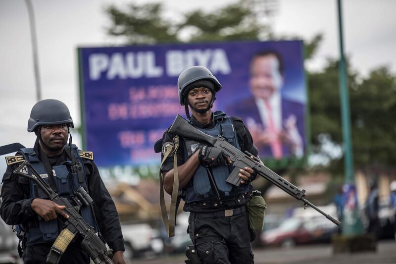 (FILES) In this file photo taken on October 03, 2018 Members of the Cameroonian Gendarmerie patrols in the Omar Bongo Square of Cameroon's majority anglophone South West province capital Buea during a political rally of the ruling CPDM party, Cameroon People's Democratic Movement of incumbent Cameroonian President Paul Biya. Surrounded by security and political crises and military blunders, the Cameroon of the unshakable President Paul Biya appears embarrassed, forced to let go under intense pressure from human rights defenders, international NGOs, the UN and previously less willing allies.    / AFP / MARCO LONGARI

