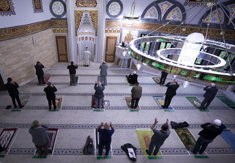 BERLIN, GERMANY - MAY 24: Muslims wearing protective masks and maintaining the social distancing as a preventive measure against the spread of coronavirus (COVID-19) perform Eid al-Fitr prayer at the Mevlana mosque in Berlin, Germany on May 24, 2020. Eid al-Fitr marks the end of the Islamic fasting month of Ramadan. (Photo by Abdulhamid Hosbas/Anadolu Agency via Getty Images)