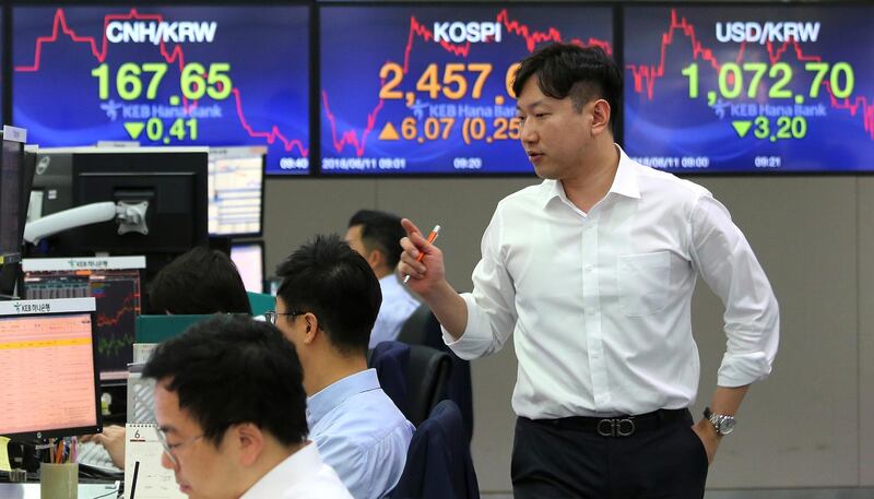 A currency trader works at the foreign exchange dealing room of the KEB Hana Bank headquarters in Seoul, South Korea, Monday, June 11, 2018. Asian markets were mixed Monday before President Donald Trump planned to meet North Korean leader Kim Jong Un and after his outburst at Canada's prime minister over trade. (AP Photo/Ahn Young-joon)