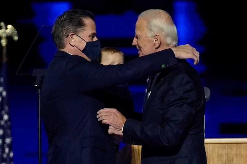 FILE - In this Nov. 7, 2020, file photo, President-elect Joe Biden, right, embraces his son Hunter Biden, left, in Wilmington, Del. Bidenâ€™s son Hunter says he has learned from federal prosecutors that his tax affairs are under investigation.  (AP Photo/Andrew Harnik, Pool)