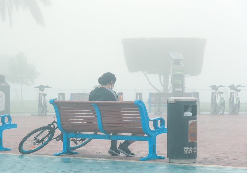 Residents enjoy the foggy weather in Corniche. Victor Besa / The National