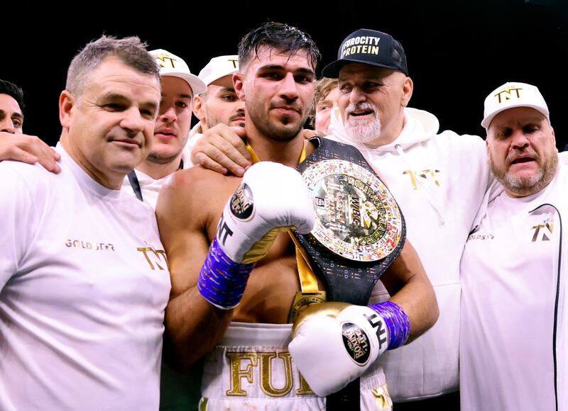 Tommy Fury poses for photographs with his coaching team. PA