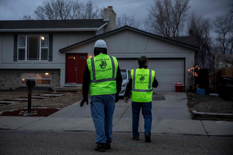 Construction crews survey damage from the debris at a property in Broomfield. AFP