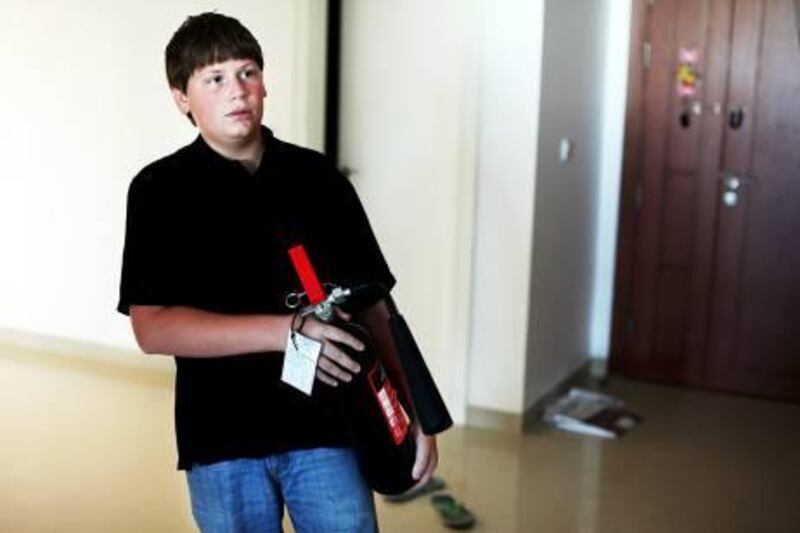 Abu Dhabi, United Arab Emirates --- October 31, 2010 --- Ian Hillman, 13, who has only been in Abu Dhabi since July, reacted with quick thinking and instinct as he grabbed a fire extinguisher from the kitchen of a Khalidiya flat after noticing fire in the flat across the hall from him.  His quick action kept damage in the unit to a minimum.   ( DELORES JOHNSON / The National )