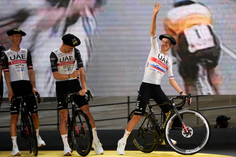 Tadej Pogacar waves during the team presentation ahead of the Tour de France. AP