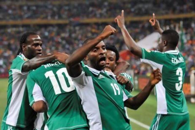 Nigeria forward Sunday Mba, centre, celebrates with teammates after scoring in a 1-0 win over Burkina Faso in the African Cup of Nations final on Sunday. Issouf Sanogo / AFP