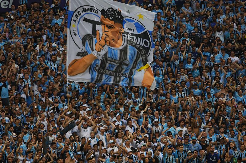 A huge flag of Luis Suarez is held up by Gremio fans during the match. AFP