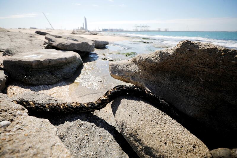 A rope covered in tar is seen on rocks at a beach in Ashdod. Reuters