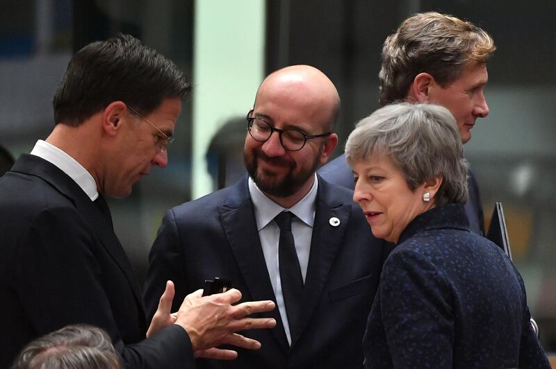 (FromL) Netherlands' Prime Minister Mark Rutte, Belgium's Prime Minister Charles Michel and Britain's Prime Minister Theresa May talk to each other on March 21, 2019 in Brussels on the first day of an EU summit focused on Brexit. European Union leaders meet in Brussels on March 21 and 22, for the last EU summit before Britain's scheduled exit of the union. / AFP / EMMANUEL DUNAND
