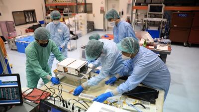 A team from Japan's space agency Jaxa works on the Omotenashi CubeSat. Photo: Nasa