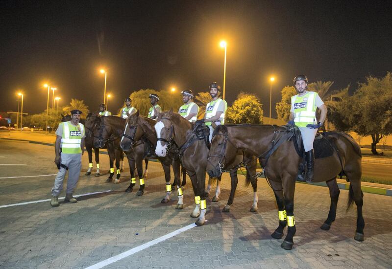 Abu Dhabi, United Arab Emirates- Police officers preparing to do patrol in a horse in Al Mushrif.  Leslie Pableo for The National for Haneen Dajani's story