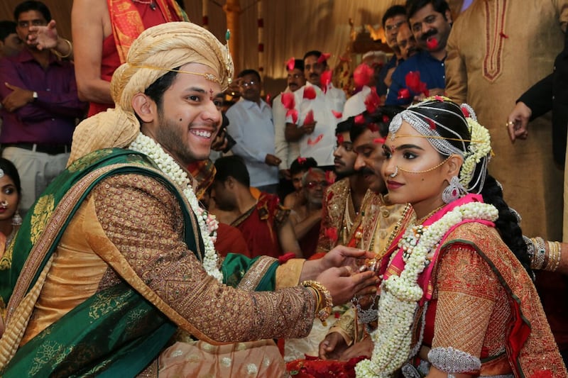Mining baron Gali Janardhana Reddy's daughter, Brahmani, right, with her groom, Rajeev Reddy, during their wedding at the Bangalore Palace grounds. The wedding reportedly cost 5 billion rupees. AFP