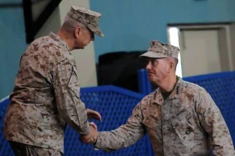 Gen Joseph Dunford, right, the new International Security Assistance Force (ISAF) commander, shakes hands with outgoing ISAF commander Gen John Allen (left) after a change-of-command ceremony at the Nato-led ISAF headquarters in Kabul.
