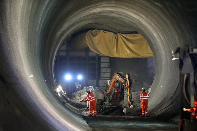 Workers prepare the walls in the partially completed Crossrail rail tunnel that will become Bond Stret station. Peter Macdiarmid / Getty Images
