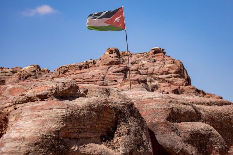 A Jordan national flag appears amid the rocky formations at the reopened Petra archeological site. EPA