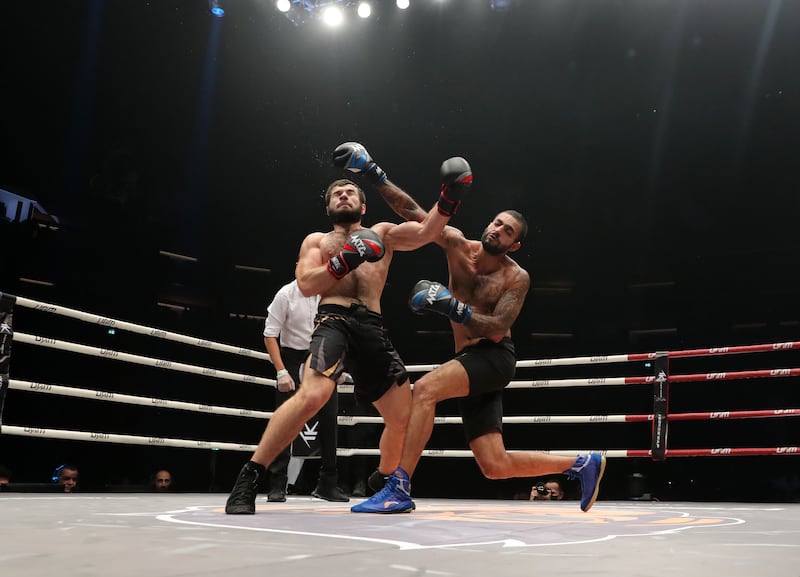 King Anobis (blue gloves) takes on Hamza Yamadaev (red gloves) at the Social Knockout at the Coca-Cola Arena in Dubai.