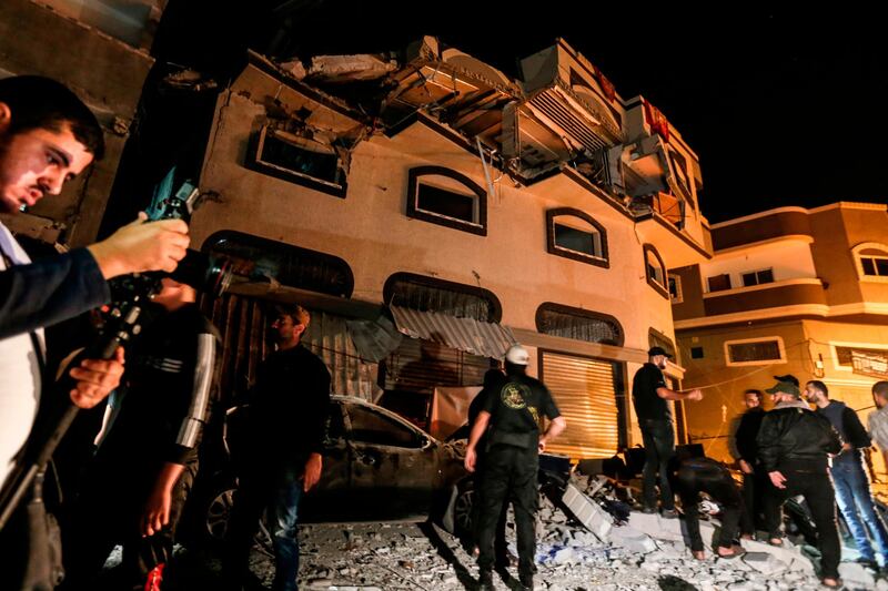 Palestinians inspect the damaged house of Islamic Jihad leader Baha Abu Al Ata  afther an Israeli attack in Gaza city. AFP
