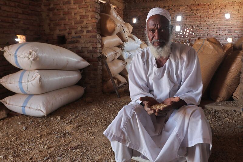 Sudanese farmer Modawi Ahmed is pictured inside his granary in the village of al-Laota, about 70 kilometres southwest of the capital Khartoum on May 28, 2022.  - Impoverished Sudan has for years been grappling with a grinding economic crisis, which deepened after last year's military coup prompted Western governments to cut crucial aid.  The October coup derailed a fragile transition put in place following the 2019 ouster of president Omar al-Bashir.  (Photo by ASHRAF SHAZLY  /  AFP)