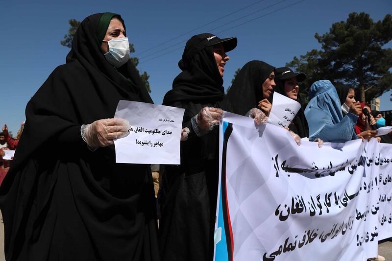 epa08414991 Afghans shout slogans outside the Iranian consulate during a protest against the Iranian regime and demand justice for the Afghans allegedly killed by the Iranian security forces, in Herat, Afghanistan, on May 11, 2020. EPA