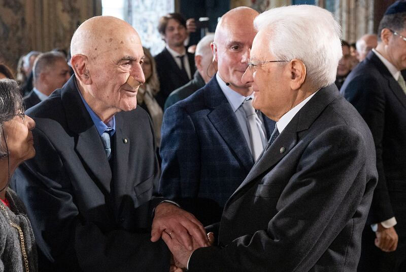 Italian President Sergio Mattarella talks to Holocaust survivor Sami Modiano, left, in Rome. AP