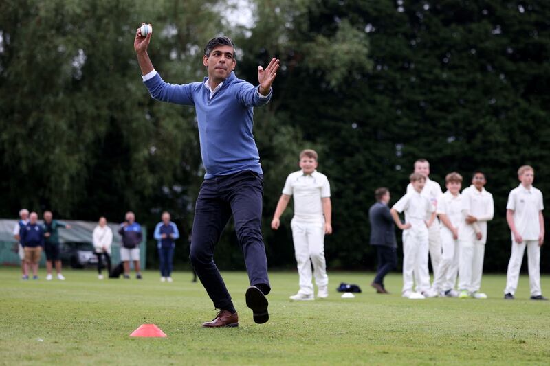 Mr Sunak bowls during his visit to Nuneaton Cricket Club. AFP