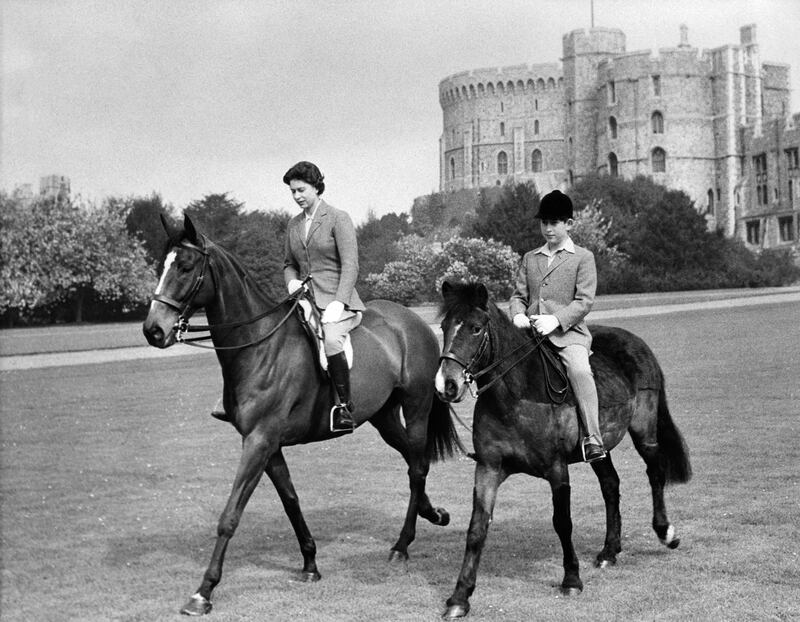 An undated image of Queen Elizabeth II and Prince Charles riding horses in the park of Windsor Castle. AFP
