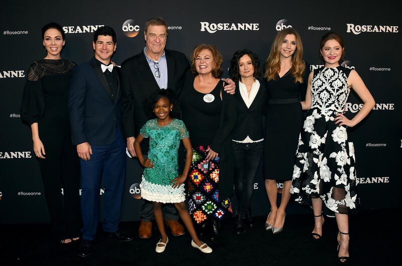 FILE - In this March 23, 2018 file photo, from left, Whitney Cummings, Michael Fishman, John Goodman, Jayden Rey, Roseanne Barr, Sara Gilbert, Sarah Chalke and Emma Kenney arrive at the Los Angeles premiere of "Roseanne" in Burbank, Calif. ABC, which canceled its "Roseanne" revival over its star's racist tweet, said Thursday, June 21, 2018, it will air a Conner family sitcom minus Roseanne Barr this fall. (Photo by Jordan Strauss/Invision/AP, File)