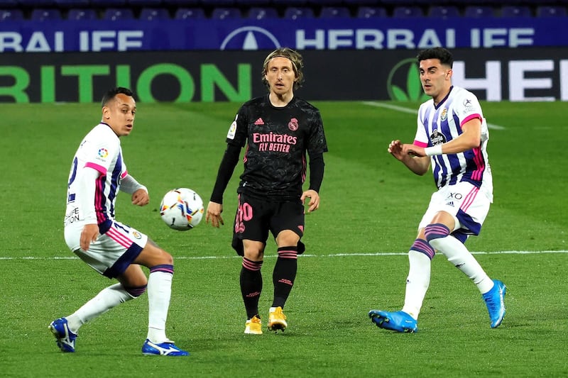 Real Madrid's Luka Modric, centre, in action against Real Valladolid's Fabian Orellana. EPA