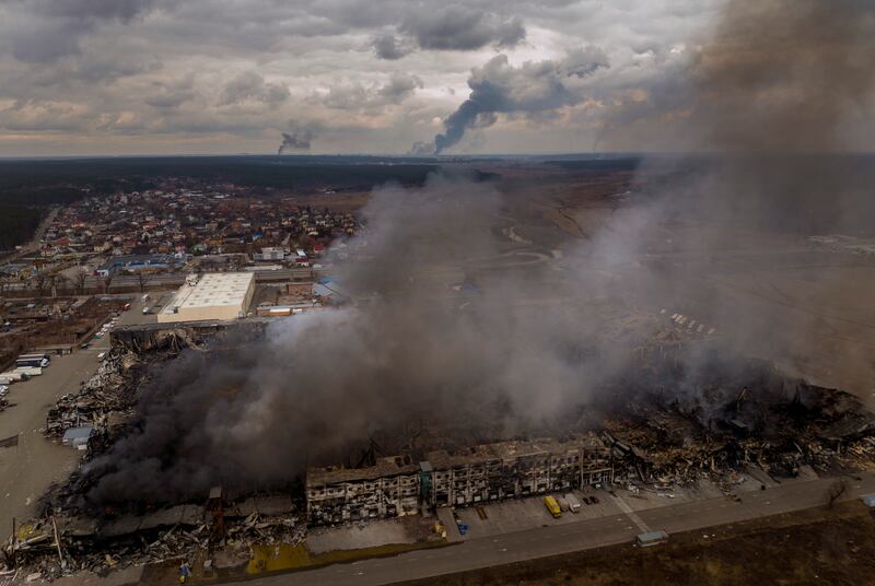 A factory and warehouse burn after being bombarded in Irpin. AP