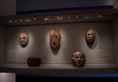 One of the masks in American billionaire Michael Steinhardt's collection, centre, is displayed at the Israel Museum in Jerusalem. AP