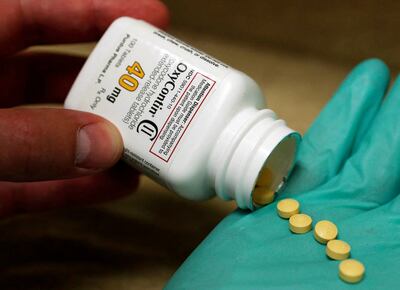 A pharmacist holds prescription painkiller OxyContin, one of the drivers of the opioid crisis. Reuters