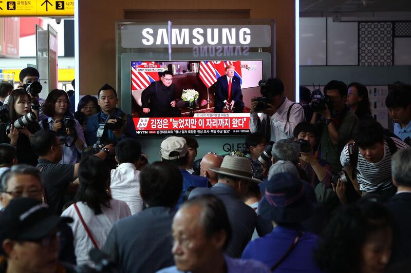 South Koreans watch a screen reporting on US President Trump meeting with North Korean leader Kim Jong-un at the Seoul Railway Station in Seoul, South Korea. Chung Sung-Jun / Getty Images