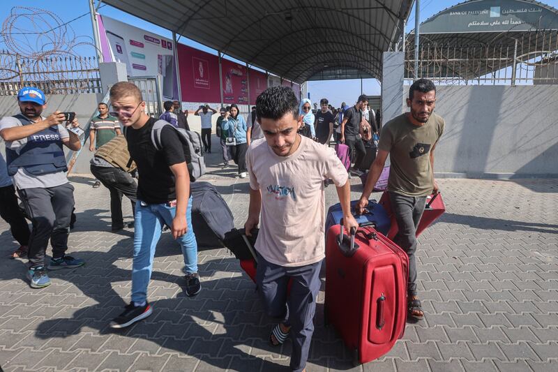 Palestinians with dual citizenship pictured at Gaza's Rafah border crossing with Egypt on Wednesday. There have been suggestions of pushing millions of Gazans into the barren, mountainous Sinai Peninsula. Bloomberg
