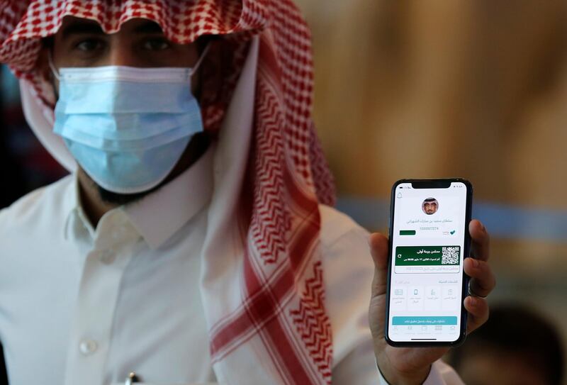 Sultan Saeed Al-Shahrani shows his vaccination certificate on his mobile phone at a checkpoint at King Abdulaziz International Airport, Saudi Arabia. AP Photo