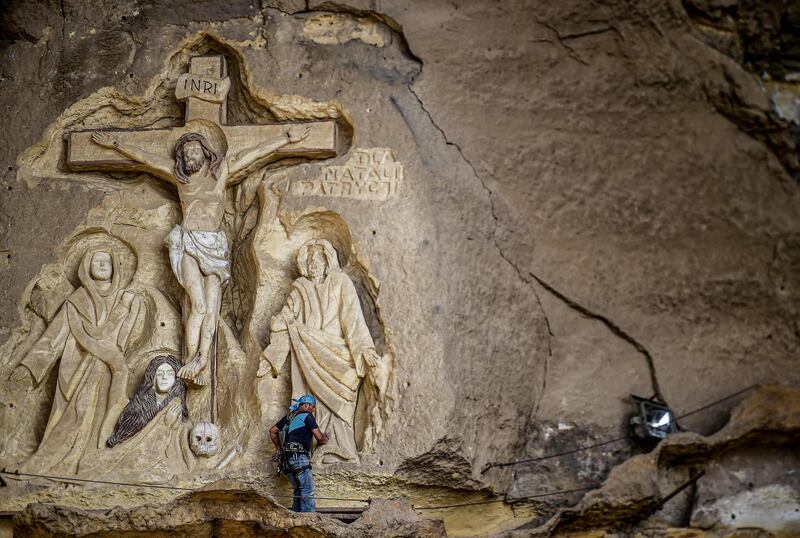 Polish artist Mario, sculptor of St. Simon the Tanner Monastery complex, works on a scene relief depicting the Crucifixion of Jesus Christ, at the church in the Egyptian capital Cairo's eastern hillside Mokattam district. Mario spent more than two decades carving the rugged insides of the seven cave churches and chapels of the rock-hewn St. Simon Monastery and church complex atop Cairo's Mokattam hills, with designs inspired by biblical stories. It was all done to fulfil the wishes of the church's parish priest who met Mario in the early 1990s in Cairo. The Polish artist, who had arrived in Egypt earlier on an educational mission, was then looking for an opportunity to serve God at the monastery. AFP