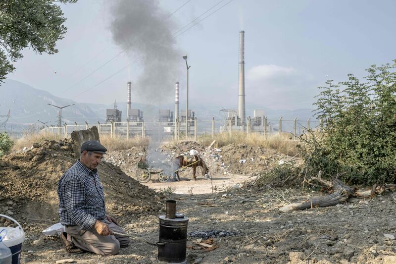 Osman Arslan, 75, prepares a pot of tea before working in his field adjacent to the coal-fired Soma power plant in the west of the country. 