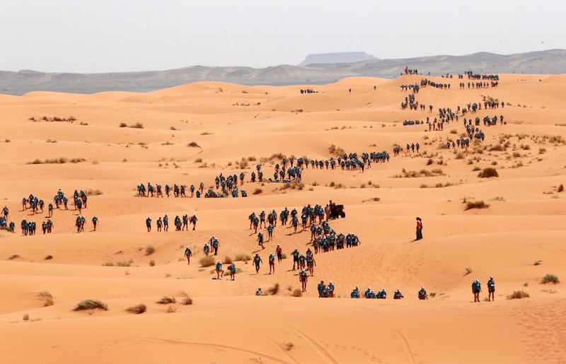 Participants cross the dunes of Merzouga on the final stage of the 28th Marathon des Sables two years ago. The final leg of the race is a charity stage to raise funds for Unicef.  Pierre Verdy / AFP