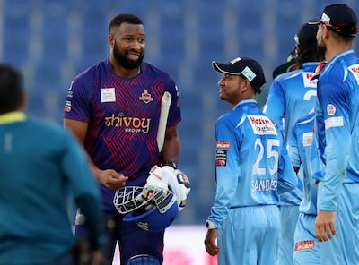 Abu Dhabi, United Arab Emirates - November 18, 2019: Deccan Gladiators Kieron Pollard chats with Karnataka Tuskers Sandeep Lamichhane during the game between Karnataka Tuskers and Deccan Gladiators in the Abu Dhabi T10 league. Monday the 18th of November 2019. Zayed Cricket Stadium, Abu Dhabi. Chris Whiteoak / The National